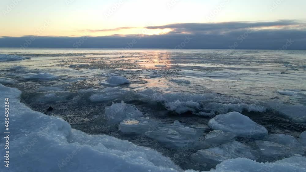 Waves crashing on the shores of Lake Superior icebergs formations floting on the water winter morning Waves crashing on the shores of Lake Superior icebergs formations floting on the water winter morning
