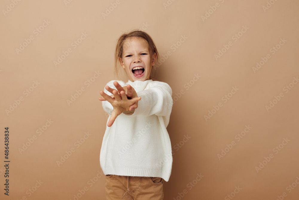 little girl in white sweater posing hand gestures Lifestyle unaltered