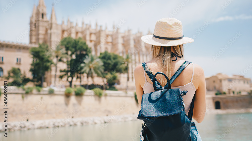 Fototapeta premium Young attractive smiling girl tourist exploring new city at summer
