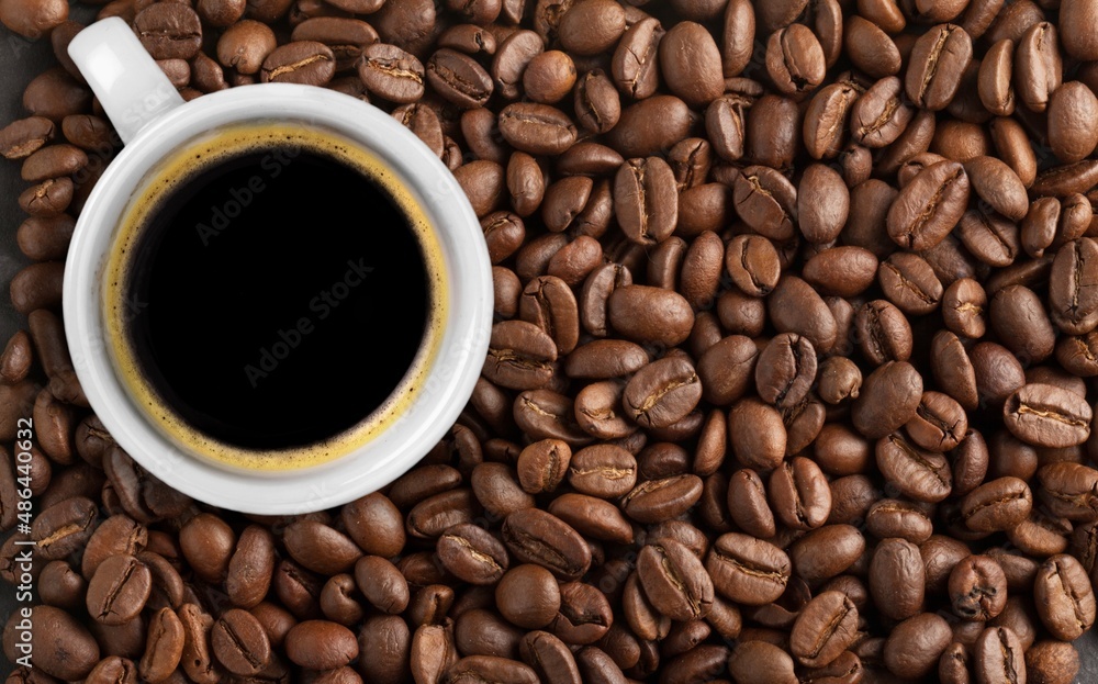 Fototapeta premium Cup of coffee with aroma roasted beans
