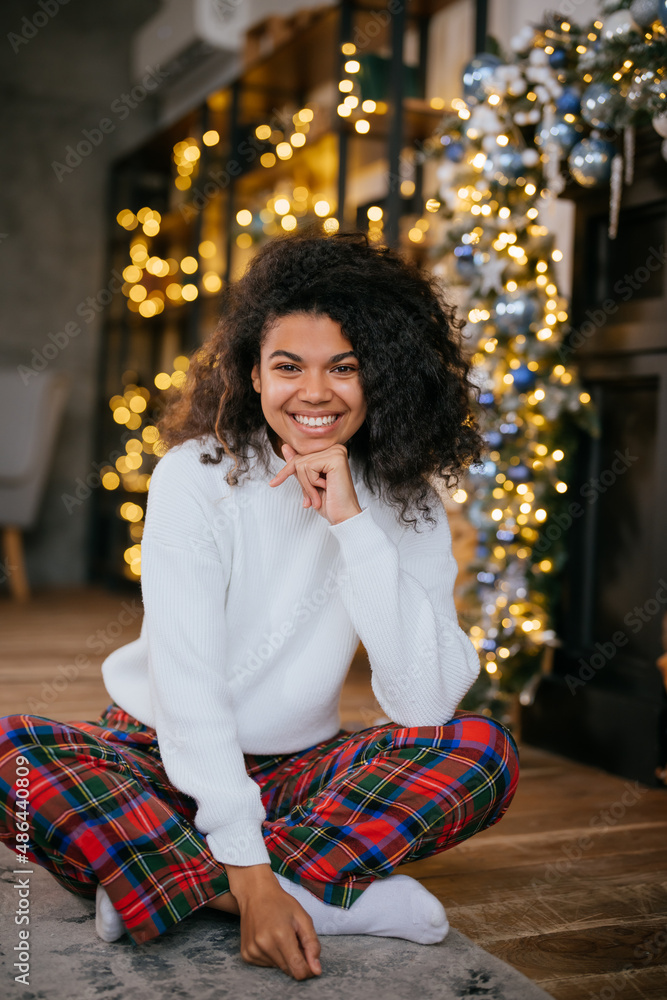 Fototapeta premium Beautiful young african american woman on the floor