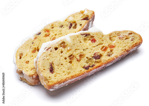 Slices of Traditional Christmas stollen cake with marzipan and dried fruit isolated on white background