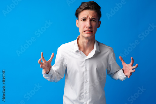 Valokuva Furious teen guy shouting over blue background
