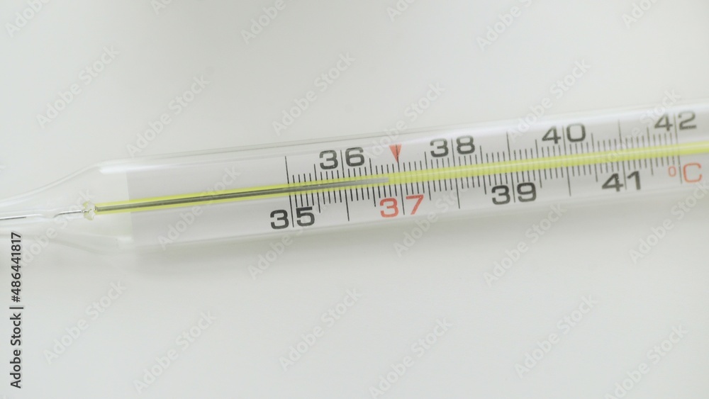 A close-up of a glass mercury thermometer shows a low temperature A close-up of a glass mercury thermometer shows a low temperature
