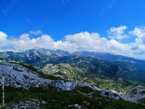 View of the Triglav mountain shrouded in clouds the Julian alps in Gorenjska region of Slovenia with alpine landscape covered with meadows and creeping pine in below the mountains