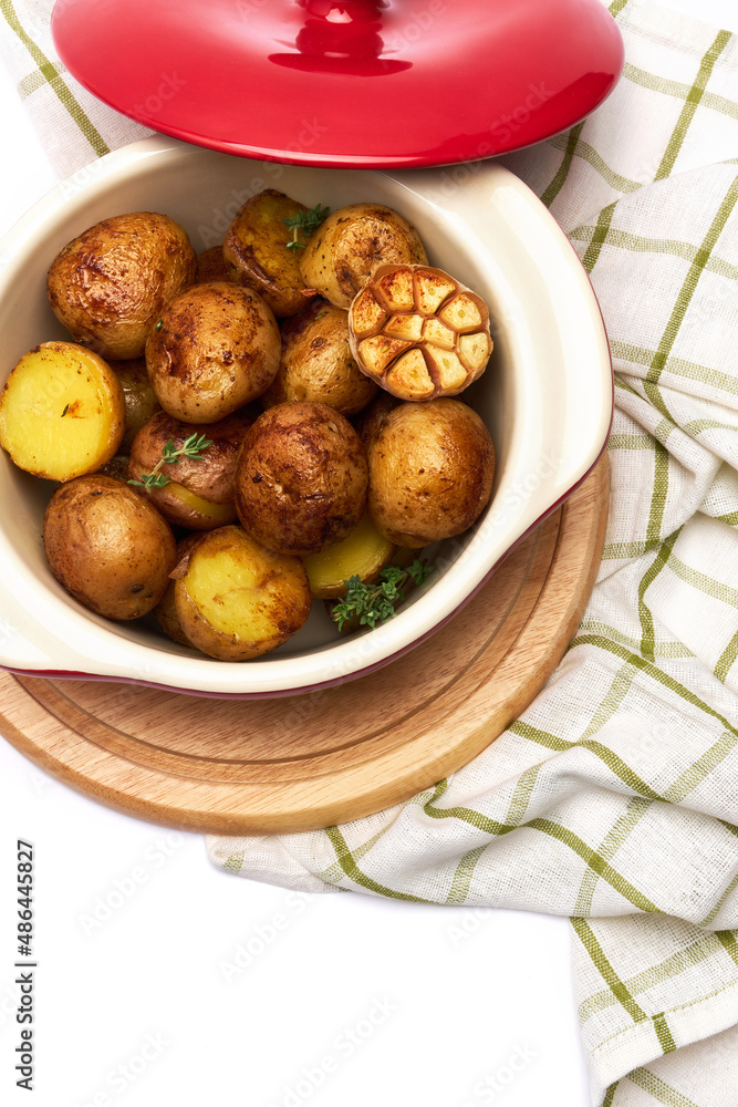 Baked potato in a clay pot isolated on white background Baked potato in a clay pot isolated on white background