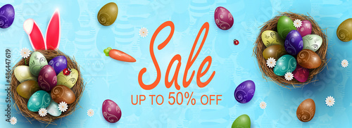 Composition with Easter eggs in nests, rabbit ears