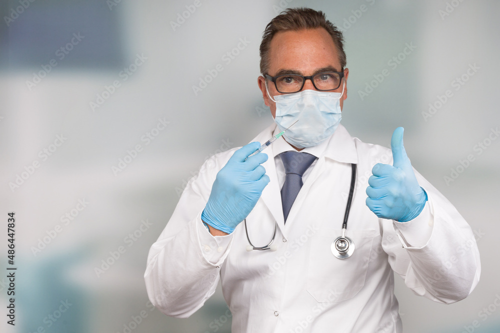 male doctor wearing a medical face mask and medical gloves shows thumbs up male doctor wearing a medical face mask and medical gloves shows thumbs up