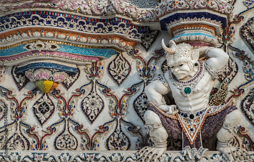 Elaborate sculptures of monster is made of bricks and mortar  decorated with various colored glazed tiles at the chapel of The Pariwas Ratchasongkram temple. Selective Focus.
