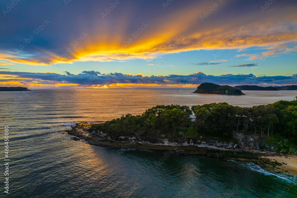 Fototapeta premium Aerial sunrise seascape with overcast sky and rain clouds