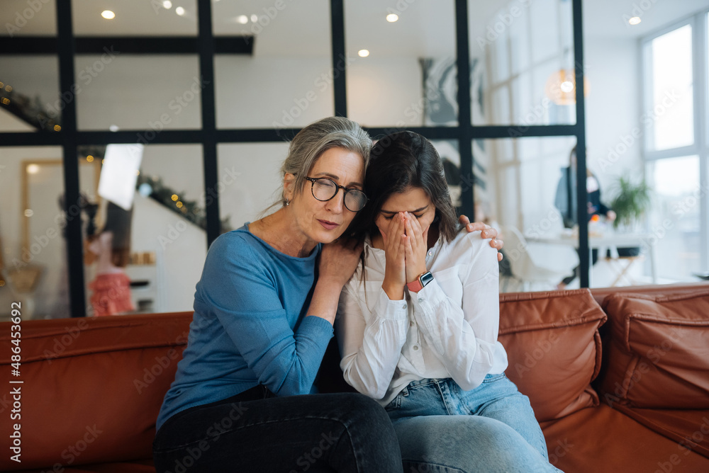 Fototapeta premium Grandmother comforting her sad granddaughter at home.