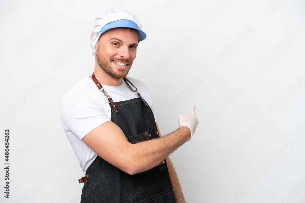 Fishmonger man wearing an apron isolated on white background pointing back Fishmonger man wearing an apron isolated on white background pointing back