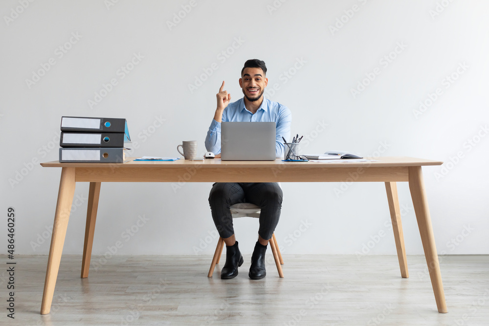Idea Concept. Excited Man Pointing Finger Up At Workplace Idea Concept. Excited Man Pointing Finger Up At Workplace