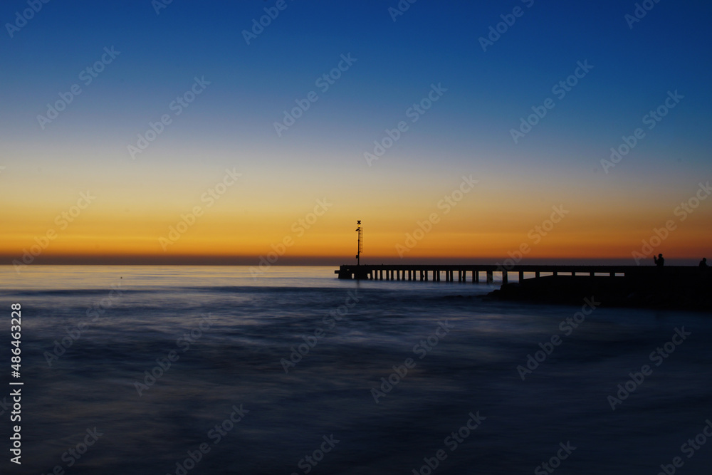 pier after the sunset with sky and sea