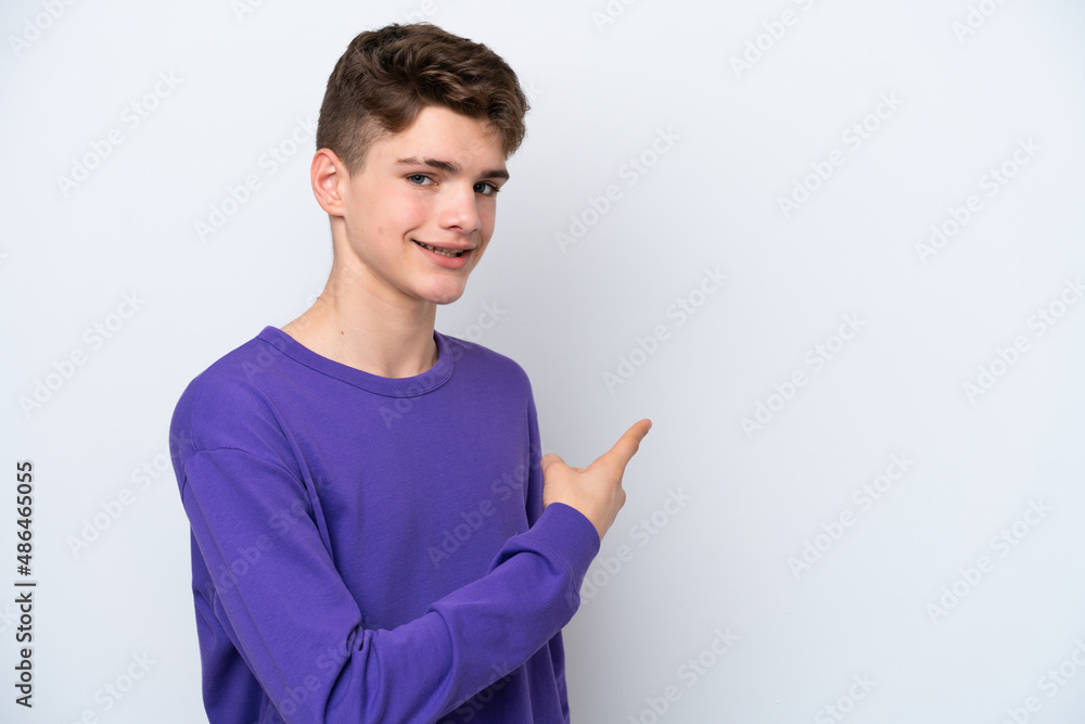 Teenager Russian man isolated on white background pointing back Teenager Russian man isolated on white background pointing back