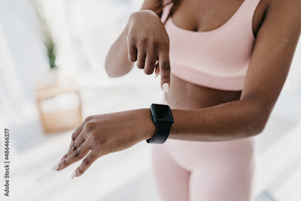 Fototapeta premium Unrecognizable young black woman pointing at fitness tracker with mockup, having workout break, checking heart rate