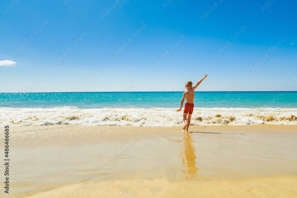 kid on vacations at seaside running in the water kid on vacations at seaside running in the water
