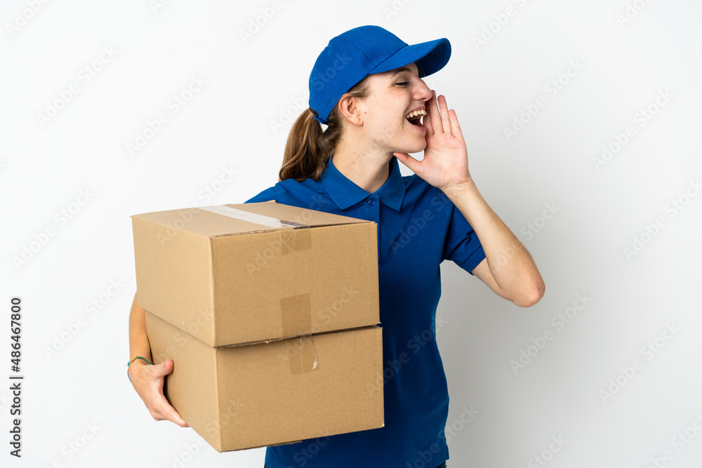 Young delivery woman isolated on white background shouting with mouth wide open to the side Young delivery woman isolated on white background shouting with mouth wide open to the side