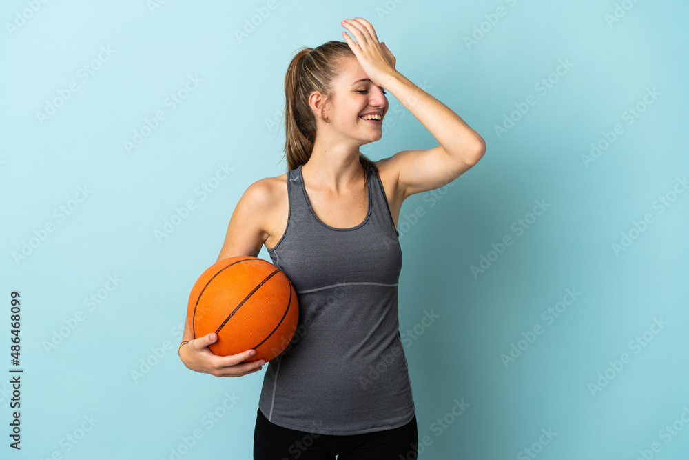 Young woman playing basketball isolated on blue background has realized something and intending the solution