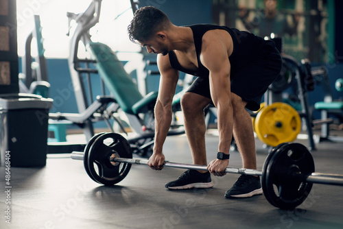 Portrait Of Muscular Middle Eastern Guy Making Deadlift Workout At Modern Gym