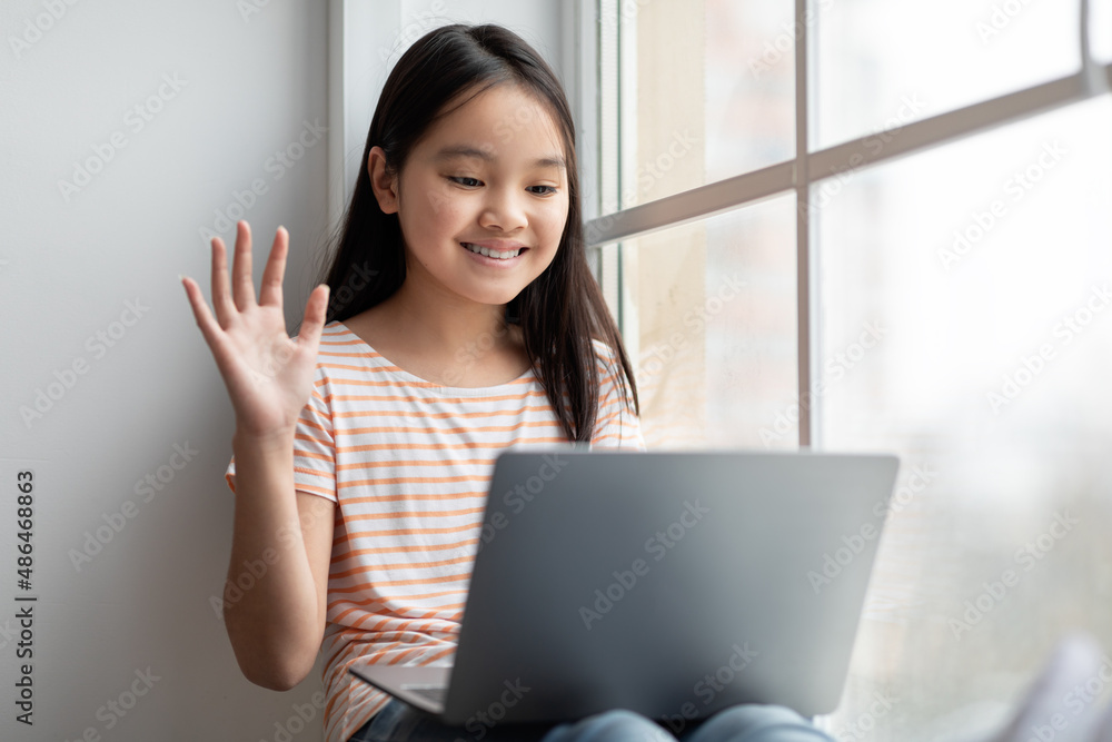 Cute asian girl teenager having video call, using laptop Cute asian girl teenager having video call, using laptop