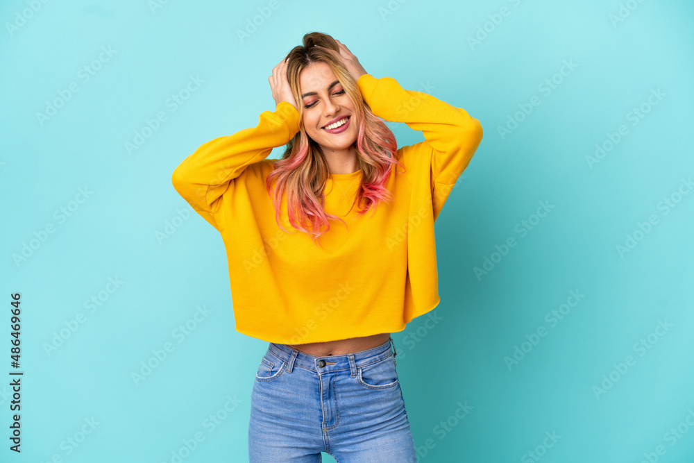 Young woman over isolated blue background laughing Young woman over isolated blue background laughing