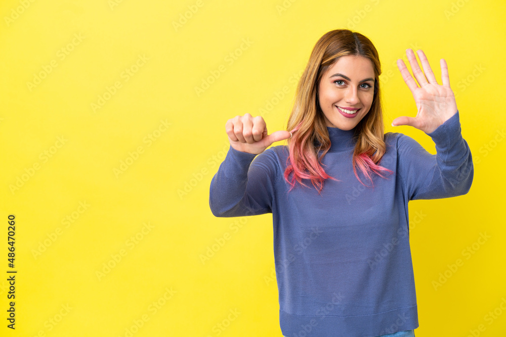 Young woman over isolated yellow background counting six with fingers Young woman over isolated yellow background counting six with fingers