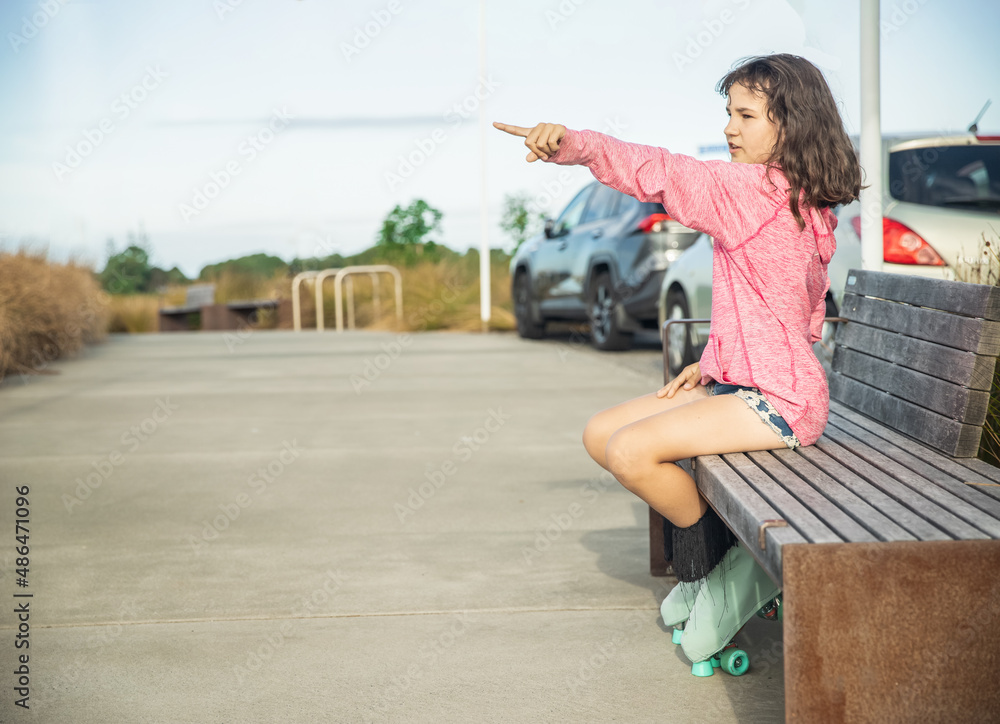 portrait of young child or teen girl roller skating outdoors, fitness, wellbeing, active healthy lifestyle. 