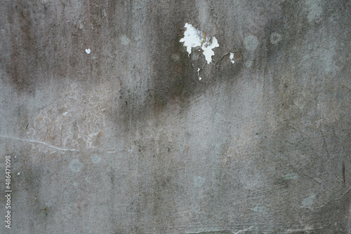 Old grunge dirty textured cement wall surface. With uneven stains and tiny holes.