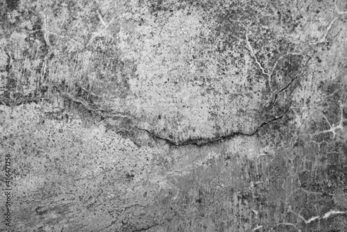 Old grunge dirty textured cement wall surface. With uneven stains and tiny holes.