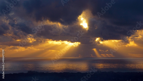 sunset and clouds with sunbeams over the sea