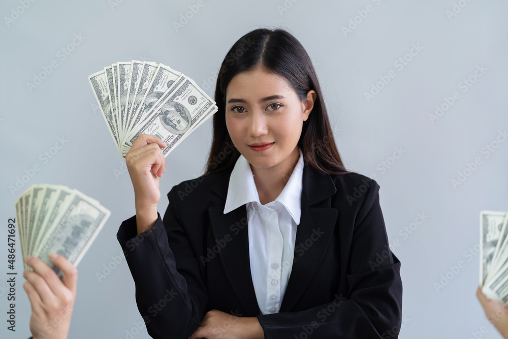 US dollars money in hand pretty young asian business woman wearing office clothing successful, business bankruptcy economic financial concept. US dollars money in hand pretty young asian business woman wearing office clothing successful, business bankruptcy economic financial concept.