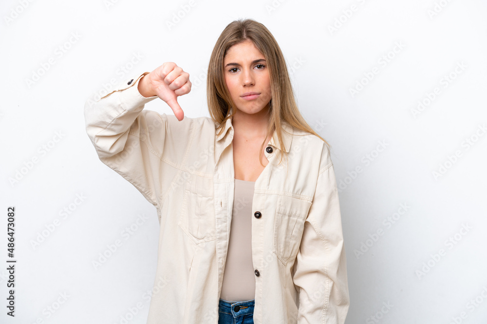 Young caucasian woman isolated on white bakcground showing thumb down with negative expression Young caucasian woman isolated on white bakcground showing thumb down with negative expression