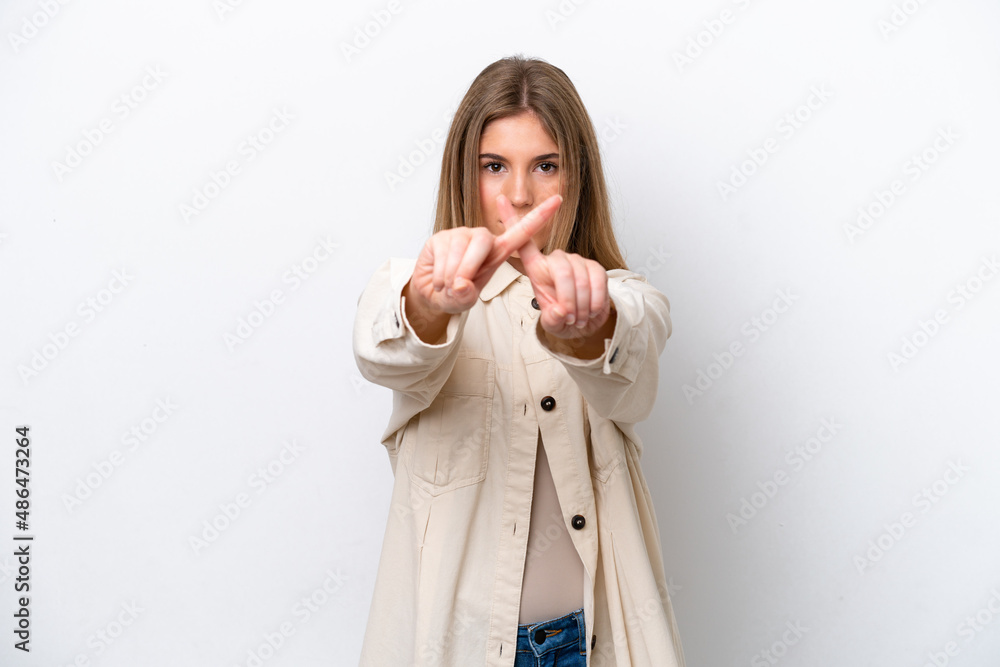 Young caucasian woman isolated on white bakcground making stop gesture with her hand to stop an act Young caucasian woman isolated on white bakcground making stop gesture with her hand to stop an act