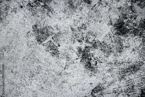 Old grunge dirty textured cement wall surface. With uneven stains and tiny holes.