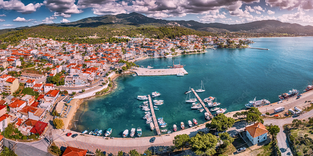 Aerial panorama of a scenic resort town Neos Marmaras with yacht marina sea port in Halkidiki, Sithonia. Travel attractions and vacation in Greece