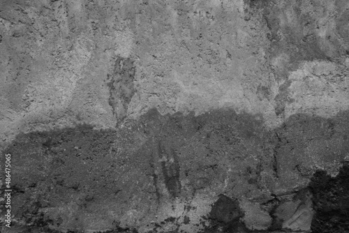 Old grunge dirty textured cement wall surface. With uneven stains and tiny holes.
