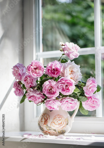 french garden pink roses in a vase on the window, summer day, cozy home, fragrances