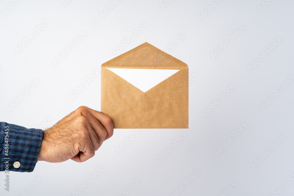 Male hands holding an envelope with a wax seal Male hands holding an envelope with a wax seal