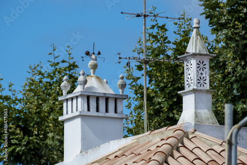 
typical chimney of Algarve on and whitewashed house in the old town of Tavira, Algarve, Portugal