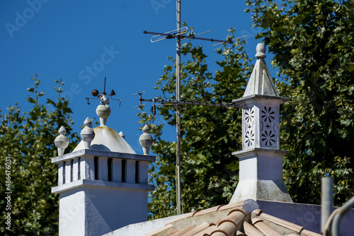 
typical chimney of Algarve on and whitewashed house in the old town of Tavira, Algarve, Portugal