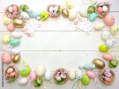 Frame of Multicolored Easter eggs on a cracked wtite antique background. Space for text