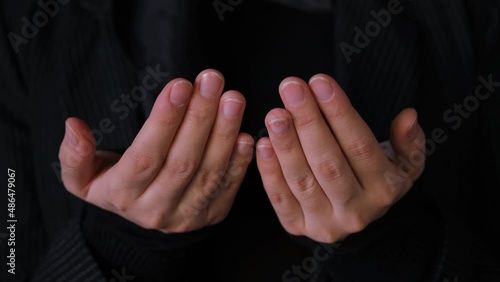 Close up of muslim women hand praying namaz at ramadan holiday. Traditional Islamic culture and religion concept.
