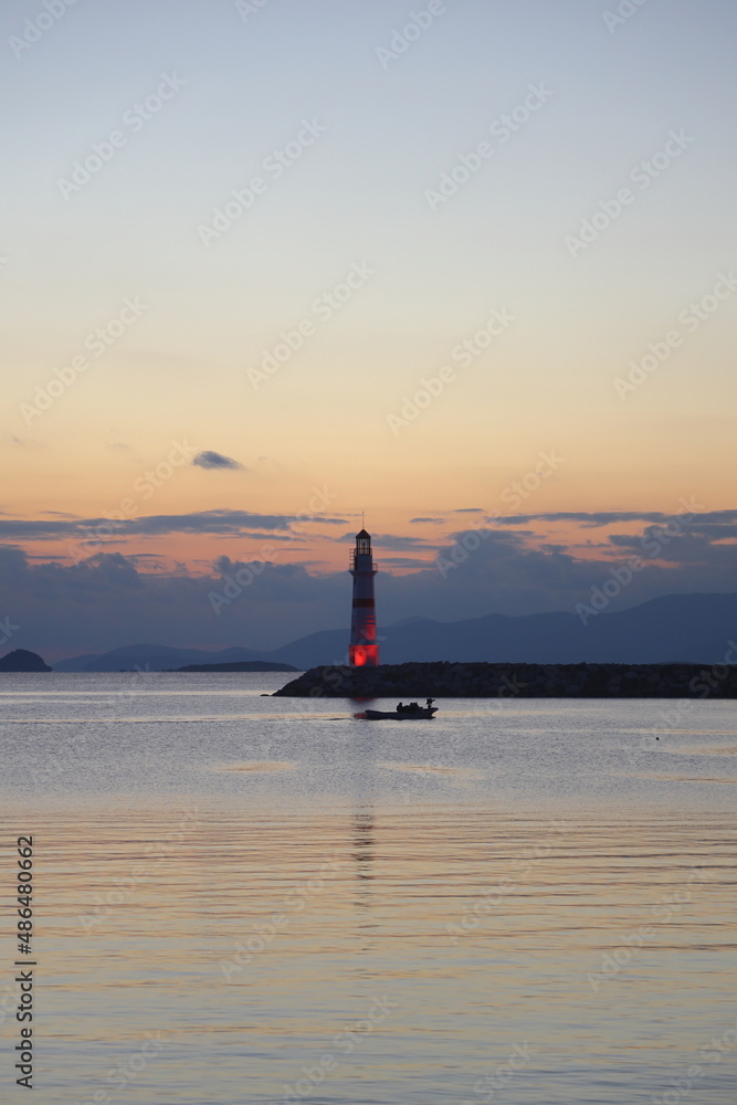 Seascape at sunshine. Lighthouse and sailings on the coast. Seaside town of Turgutreis and spectacular sunshine	
