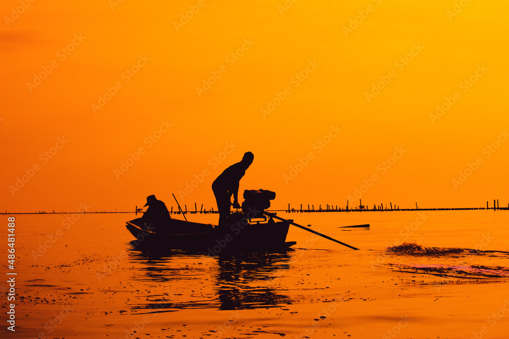 The silhouette of the fisherman lifestyle in Bang Tabun, the Gulf of Thailand, is a coastal fishery that is linked to environmental preservation and ecological balance.