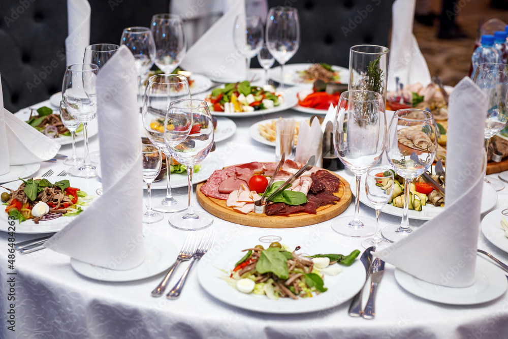 Plate with salad on the banquet table.