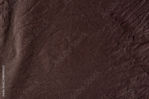 Brown crumpled cotton textile cloth for abstract background