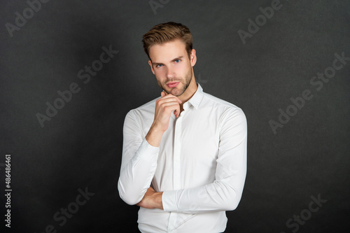 handsome businessman in shirt on black background, business