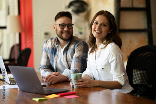 Colleagues in office. Businesswoman and businessman discussing work in office.