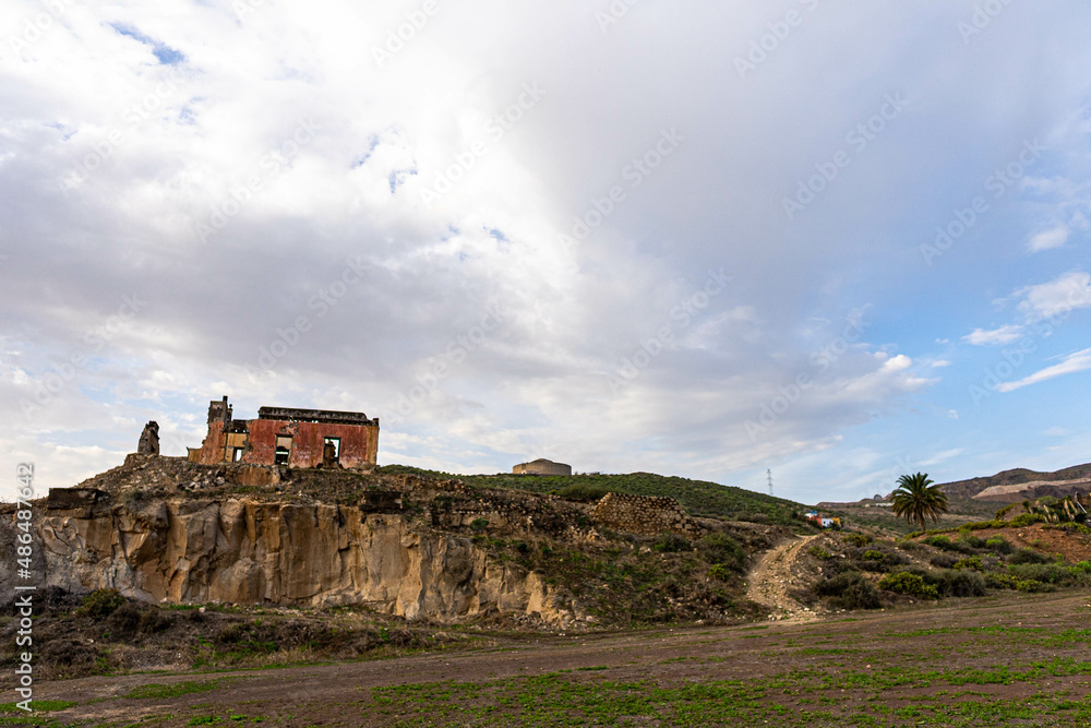 ruined castle in the canary islands in ruins with beautiful colors ruins of a bygone era of the canary islands with red colors known as the tojo de jinamar castle with ancient architecture